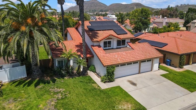 575 Nicole Dr, Newbury Park, CA 91320 - view of front of property with stucco siding, a tiled roof, concrete driveway, a mountain view, and solar panels
