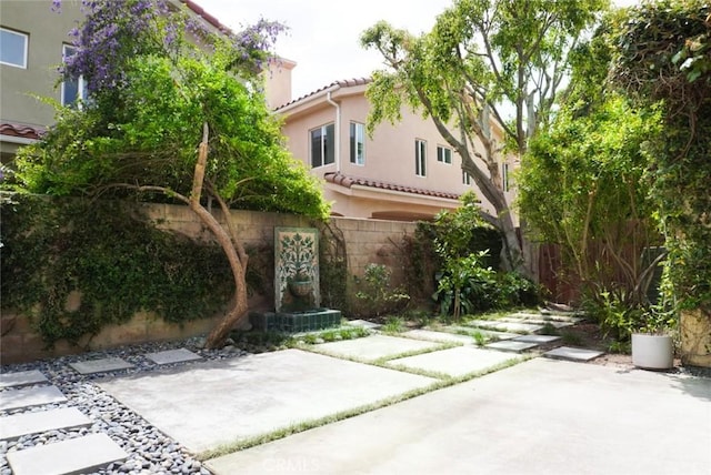 14678 Tupper St, Panorama City, CA 91402 - view of front of property featuring a fenced backyard, stucco siding, a patio area, and a tile roof