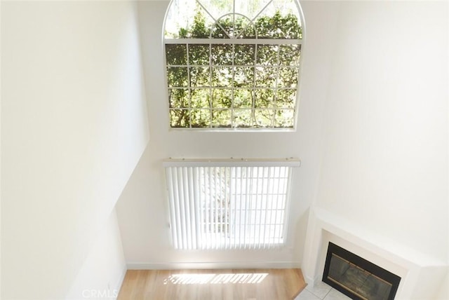 14678 Tupper St, Panorama City, CA 91402 - unfurnished living room featuring a glass covered fireplace, baseboards, and wood finished floors