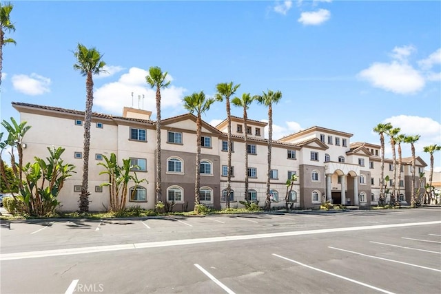 17230 Newhope St Unit 309, Fountain Valley, CA 92708 - view of building exterior with uncovered parking and a residential view