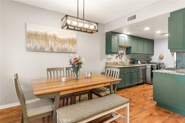 17230 Newhope St Unit 309, Fountain Valley, CA 92708 - dining area with independent washer and dryer, light wood-style floors, baseboards, and recessed lighting