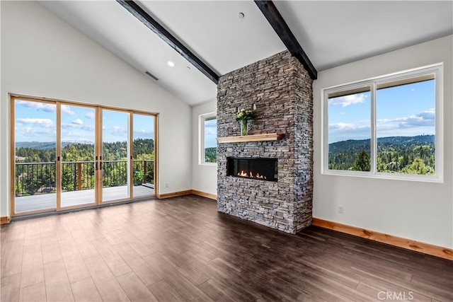 851 Madera Ln, Lake Arrowhead, CA 92352 - unfurnished living room with beamed ceiling, baseboards, a stone fireplace, plenty of natural light, and wood finished floors