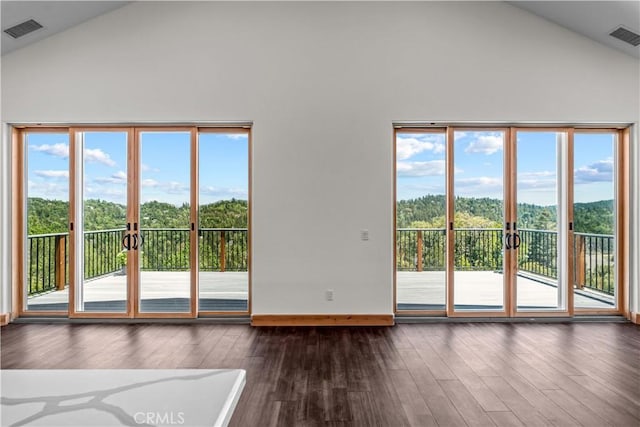 851 Madera Ln, Lake Arrowhead, CA 92352 - unfurnished living room with french doors, high vaulted ceiling, dark wood-style floors, healthy amount of natural light, and baseboards