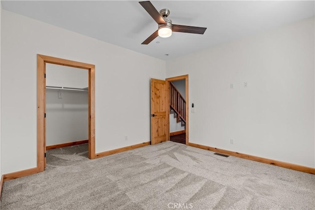 851 Madera Ln, Lake Arrowhead, CA 92352 - unfurnished bedroom with carpet floors, baseboards, a walk in closet, and ceiling fan