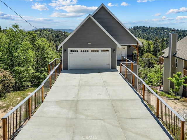 851 Madera Ln, Lake Arrowhead, CA 92352 - view of front of home featuring a view of trees, driveway, and a garage