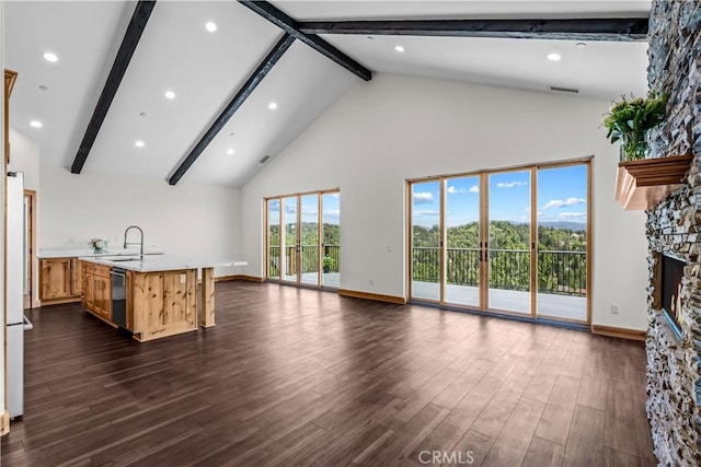 851 Madera Ln, Lake Arrowhead, CA 92352 - unfurnished living room with high vaulted ceiling, beam ceiling, dark wood-style flooring, a stone fireplace, and baseboards