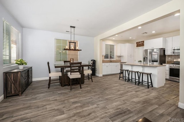 1710 Moon Orchid Ave, Chula Vista, CA 91913 - dining space with baseboards, wood finished floors, a chandelier, and recessed lighting
