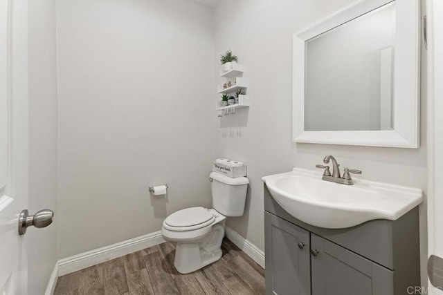 1710 Moon Orchid Ave, Chula Vista, CA 91913 - bathroom featuring vanity, toilet, wood finished floors, and baseboards