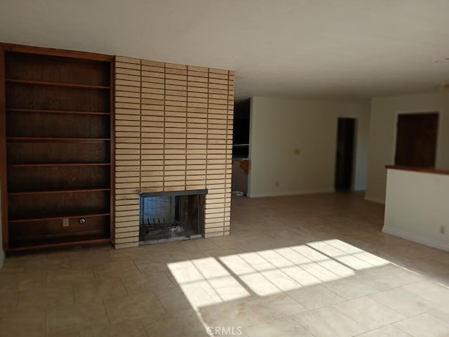 15615 Apache Rd, Apple Valley, CA 92307 - unfurnished living room featuring a fireplace and baseboards