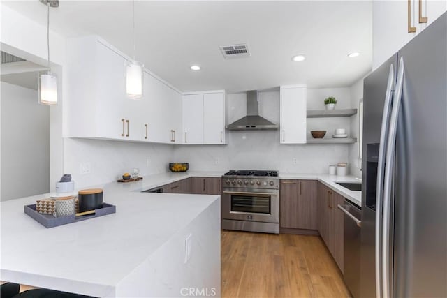 26050 Farmfield Rd, Calabasas, CA 91302 - kitchen with appliances with stainless steel finishes, wall chimney exhaust hood, light countertops, a peninsula, and open shelves