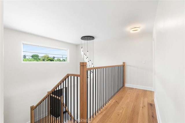 18311 Chase St, Northridge, CA 91325 - corridor featuring wood finished floors, baseboards, and an upstairs landing