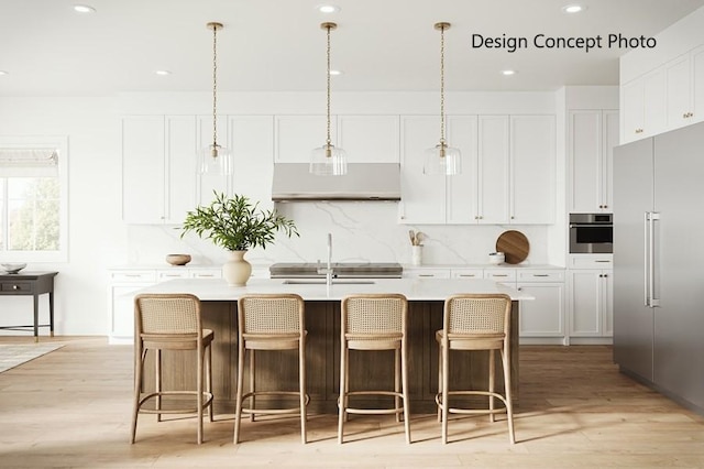 5109 Genesta Ave, Encino, CA 91316 - kitchen with under cabinet range hood, appliances with stainless steel finishes, light countertops, an island with sink, and recessed lighting