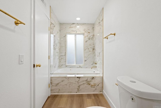 2858 Lehigh Ct, Oceanside, CA 92056 - full bath with toilet, wood finished floors, a tub with marble appearance, and baseboards