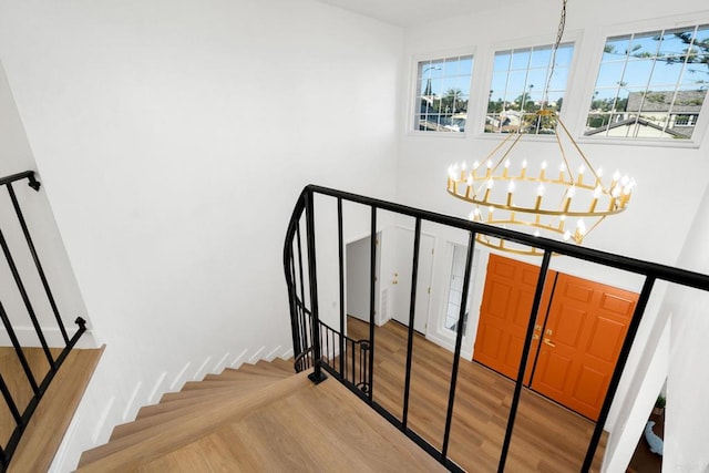2858 Lehigh Ct, Oceanside, CA 92056 - stairway with a chandelier, wood finished floors, and plenty of natural light