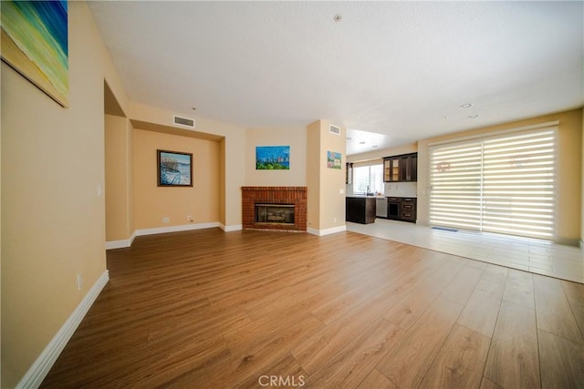 20610 E Oak Meadow Ln, Diamond Bar, CA 91765 - unfurnished living room with light wood finished floors, a fireplace, and baseboards