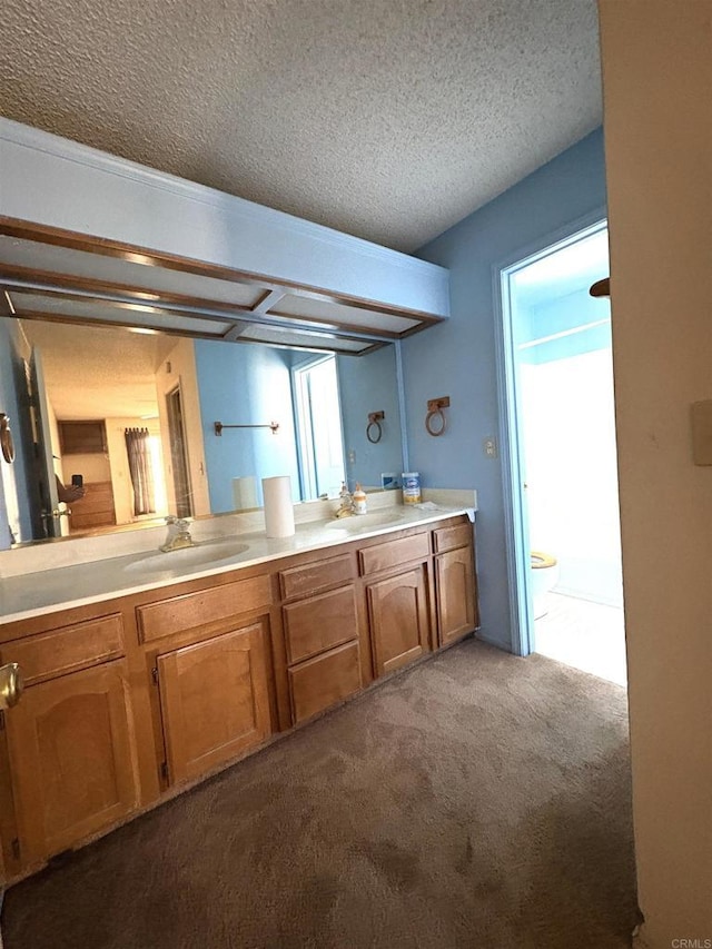 6049 N Constance Ave, Fresno, CA 93722 - full bath with carpet floors, double vanity, and a textured ceiling