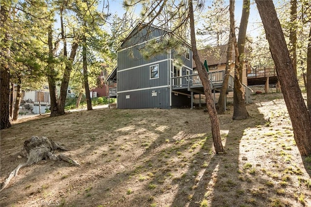 33133 Ridge Rd, Arrowbear, CA 92382 - rear view of house with a wooden deck and stairway