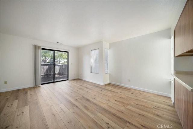 2975 Rockview Pl # 2, San Luis Obispo, CA 93401 - unfurnished living room with light wood-style flooring and baseboards