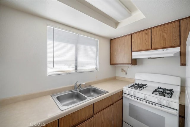 2975 Rockview Pl # 2, San Luis Obispo, CA 93401 - kitchen featuring gas range gas stove, under cabinet range hood, a sink, light countertops, and brown cabinets