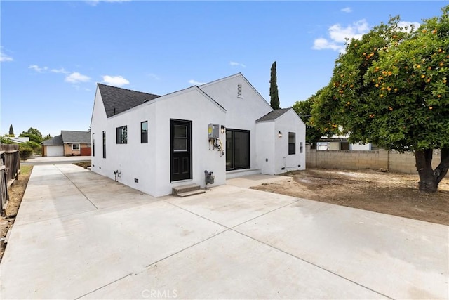 15447 Romar St, Mission Hills San Fernando, CA 91345 - back of property featuring a patio, roof with shingles, stucco siding, and entry steps