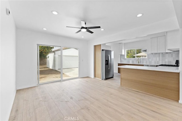 15447 Romar St, Mission Hills San Fernando, CA 91345 - kitchen with stainless steel refrigerator with ice dispenser, light countertops, a peninsula, ceiling fan, and tasteful backsplash