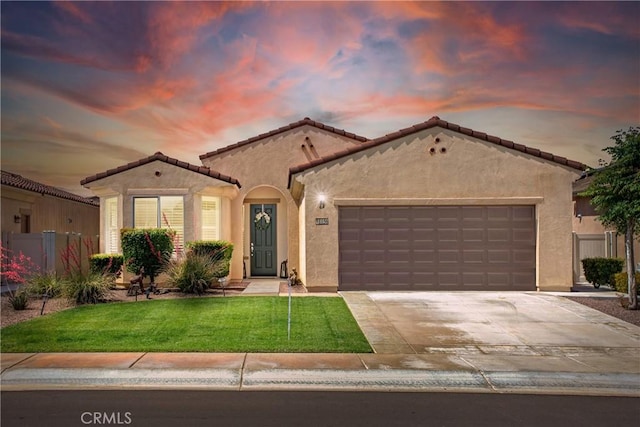 11156 Camden St, Apple Valley, CA 92308 - mediterranean / spanish-style house with stucco siding, a garage, driveway, and a tile roof