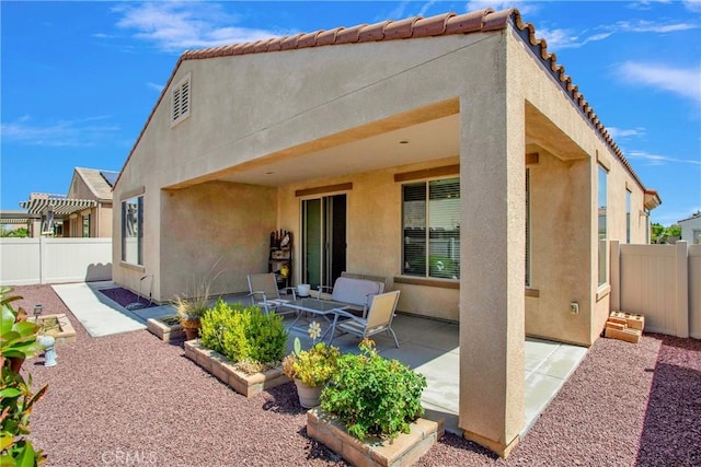 11156 Camden St, Apple Valley, CA 92308 - rear view of house with stucco siding and a patio area