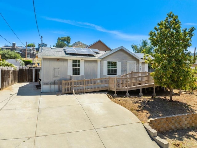 133 Frances Dr, El Cajon, CA 92019 - ranch-style home featuring a wooden deck, roof mounted solar panels, and roof with shingles
