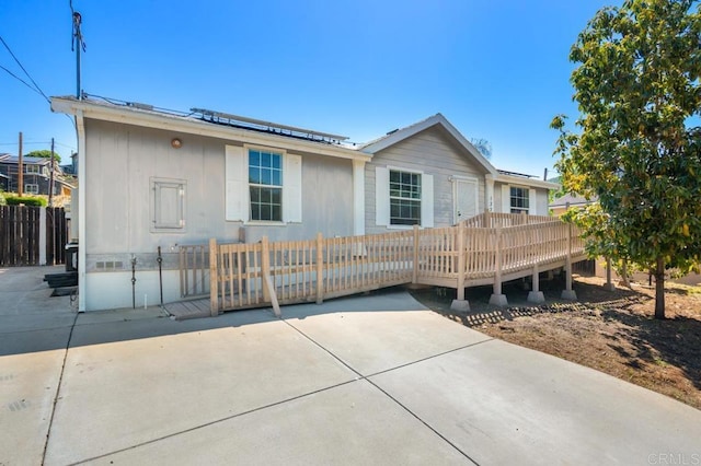 133 Frances Dr, El Cajon, CA 92019 - rear view of property with a deck, a patio area, and roof mounted solar panels