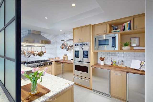 17 Muir Beach Cir, Corona Del Mar, CA 92625 - kitchen with wall chimney exhaust hood, appliances with stainless steel finishes, a warming drawer, decorative backsplash, and light brown cabinets