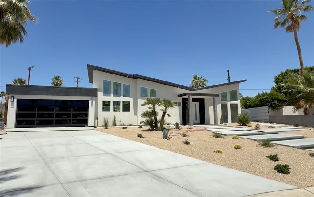 2197 Jacques Dr, Palm Springs, CA 92262 - modern home with a garage, stucco siding, and concrete driveway