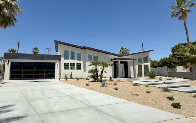 2197 Jacques Dr, Palm Springs, CA 92262 - modern home with a garage, stucco siding, and concrete driveway