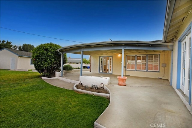 7228 Bairnsdale St, Downey, CA 90240 - back of property featuring a patio area, a yard, stucco siding, and french doors