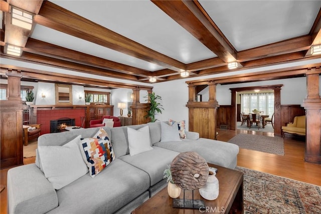 4039 W 7th St, Los Angeles, CA 90005 - living room featuring wood finished floors, beam ceiling, healthy amount of natural light, ornate columns, and a fireplace