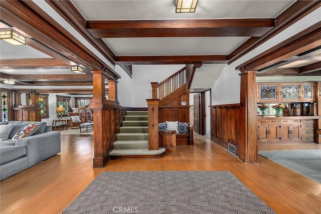 4039 W 7th St, Los Angeles, CA 90005 - staircase with wood finished floors, beam ceiling, and decorative columns