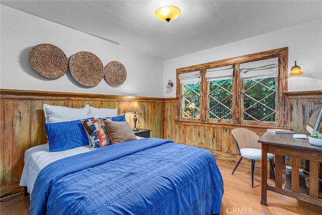 4039 W 7th St, Los Angeles, CA 90005 - bedroom featuring wood walls, a wainscoted wall, and wood finished floors