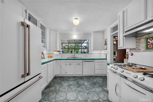 4039 W 7th St, Los Angeles, CA 90005 - kitchen featuring white appliances, a sink, white cabinetry, tile counters, and a textured ceiling