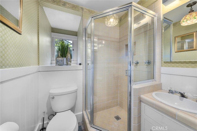 4039 W 7th St, Los Angeles, CA 90005 - bathroom featuring toilet, a stall shower, vanity, and wainscoting
