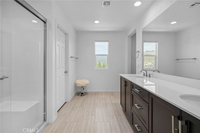 11757 Stonefield Dr, Corona, CA 92883 - bathroom featuring healthy amount of natural light, a shower stall, double vanity, baseboards, and recessed lighting