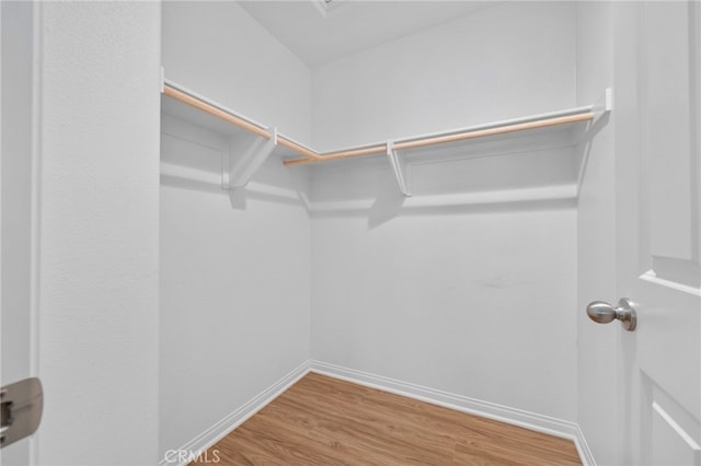 11757 Stonefield Dr, Corona, CA 92883 - walk in closet featuring wood finished floors