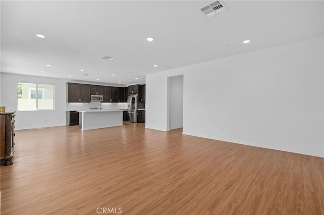 11757 Stonefield Dr, Corona, CA 92883 - unfurnished living room featuring light wood-style flooring, recessed lighting, and baseboards