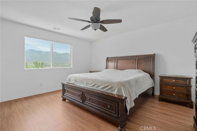 11757 Stonefield Dr, Corona, CA 92883 - bedroom with light wood-style floors, baseboards, a mountain view, and a ceiling fan