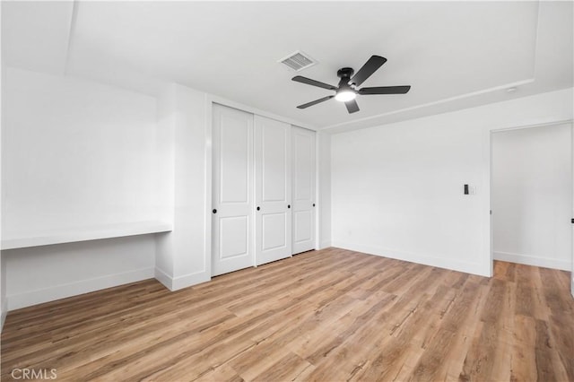 424 E Victoria St, Rialto, CA 92376 - unfurnished bedroom featuring wood finished floors, baseboards, a closet, and a ceiling fan