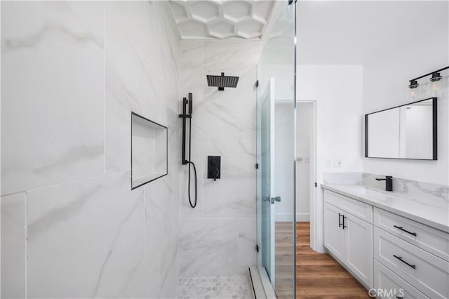 424 E Victoria St, Rialto, CA 92376 - bathroom with a marble finish shower, vanity, and wood finished floors