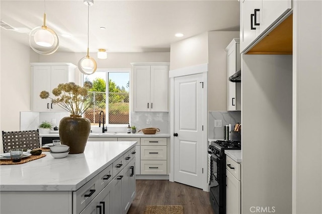 5863 Kibler Rd, Paradise, CA 95969 - kitchen featuring black gas stove, a sink, tasteful backsplash, pendant lighting, and white cabinetry