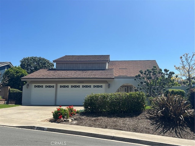 23552 Campestre, Mission Viejo, CA 92691 - view of front of house featuring driveway, an attached garage, a tiled roof, and stucco siding