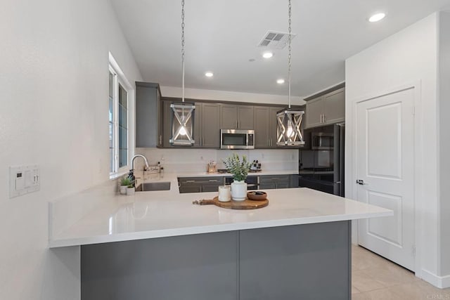35404 Domani Dr, Palm Desert, CA 92211 - kitchen featuring stainless steel microwave, gray cabinetry, light countertops, a peninsula, and recessed lighting