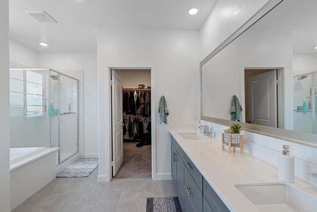 35404 Domani Dr, Palm Desert, CA 92211 - bathroom featuring a shower stall, tile patterned flooring, double vanity, a walk in closet, and recessed lighting