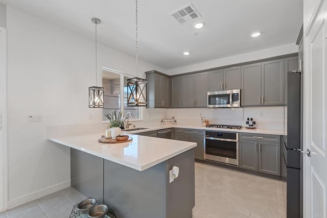 35404 Domani Dr, Palm Desert, CA 92211 - kitchen with appliances with stainless steel finishes, a peninsula, light tile patterned flooring, light countertops, and recessed lighting