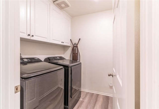 7155 Citrus Ave Unit 367, Fontana, CA 92336 - washroom featuring washing machine and clothes dryer, cabinet space, light wood-type flooring, and baseboards